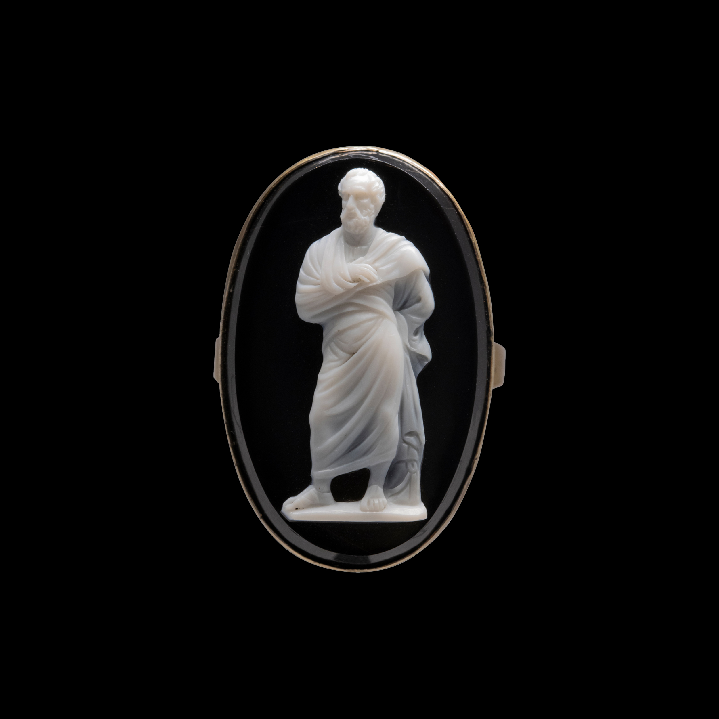 A Neoclassical onyx cameo set in a gold ring. Demosthenes. 